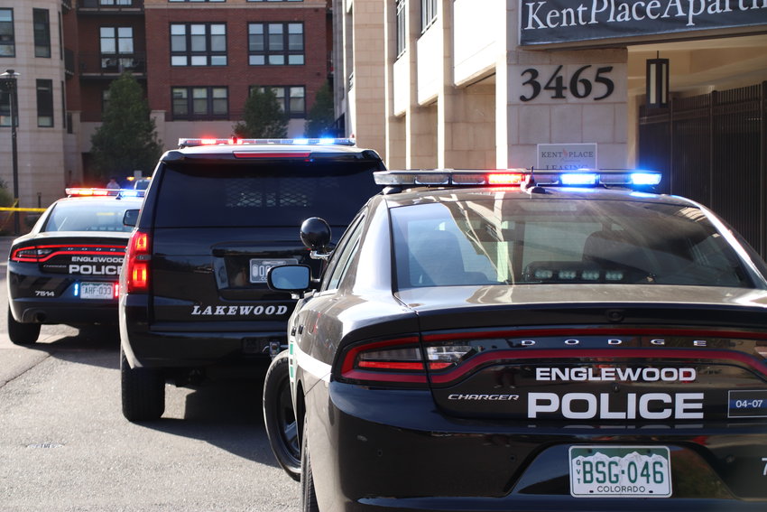Many Englewood and Lakewood police cars parked along the perimeter of the Kent Place apartments, where a car chase ended before police arrested two people.